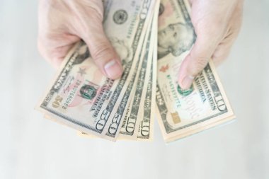 USD currency , Many dollar bank notes Placed on the table.The  Dollar is the currency of USA that is used to change, buy, sell, accumulate, and invest in united kingdom's state people.