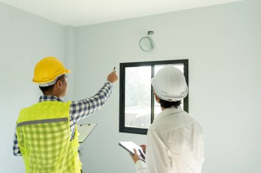 inspector engineer and owner project is inspecting construction and quality assurance new house. Engineers or architects or contactor work to build the house before handing it over to the homeowner