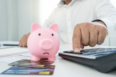 Stressed and headache man with large bills or invoices no money to pay to expenses and credit card debt. shortage, Financial problem, bankruptcy, mortgage, loan, bankrupt, poor, empty wallet 