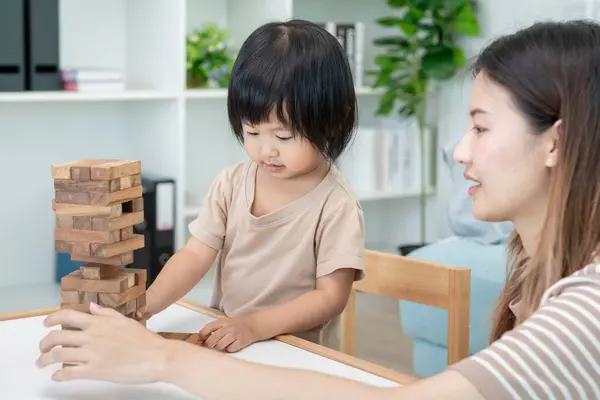 stock image Happy Asia mother play and learn toy blocks with the little girl. Funny family is happy and excited in the house. Mother and daughter having fun spending time together. Holiday, Activity, development