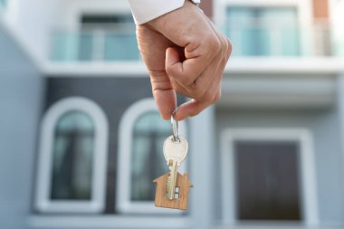 Kira, kiralama ve ev satma. Emlakçının elinde yeni sahibinin anahtarı var. Kira evi, Satış, Kredi Finansı, Sigorta, Satıcı, Satıcı, Taksit, Satın al, Sat, Taşı