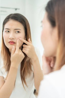 Young woman are worried about faces Dermatology and allergic to steroids in cosmetics. sensitive skin, red face from sunburn, acne, allergic to chemicals, rash on face. skin problems and beauty
