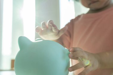 Save money. children putting coin for saving. wealth, Finance, insurance, investment, education, future, plan life, learn, banking, family, health, health and accident insurance.