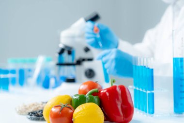 Scientist check chemical food residues in laboratory. Control experts inspect quality of fruits, vegetables. lab, hazards, ROHs, find prohibited substances, contaminate, Microscope, Microbiologist