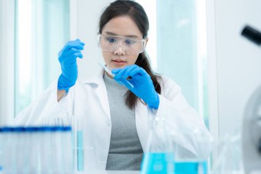 Scientist analyze biochemical samples in advanced scientific laboratory. Medical professional use dropper mix microbiological developmental of viral. Biotechnology research in  science lab. cosmetic