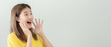 Asian beautiful woman exited surprise face expression . female feels shocked with the phone. exciting smile and happy adorable rejoices. Very enjoy and fun relax time. wow, girl holding smartphone