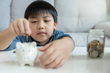 Save money. children putting coin for saving. wealth, Finance, insurance, investment, education, future, plan life, learn, banking, family, health, health and accident insurance.