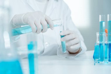 Scientist analyze biochemical samples in advanced scientific laboratory. Medical professional use dropper mix microbiological developmental of viral. Biotechnology research in  science lab. cosmetic