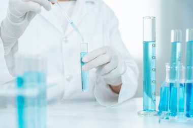 Scientist analyze biochemical samples in advanced scientific laboratory. Medical professional use dropper mix microbiological developmental of viral. Biotechnology research in  science lab. cosmetic