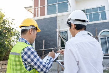 inspector engineer and owner project is inspecting construction and quality assurance new house. Engineers or architects or contactor work to build the house before handing it over to the homeowner