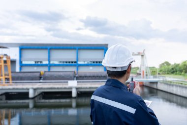 maintenance and inspector. Maintenance engineers are using walky talky to inform the results of inspection of buildings and structures. Irrigation engineers are exploring sluice systems clipart