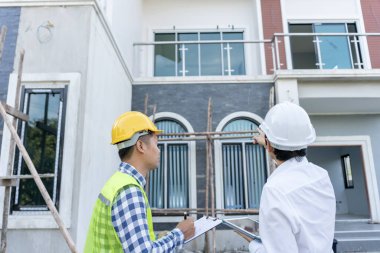inspector engineer and owner project is inspecting construction and quality assurance new house. Engineers or architects or contactor work to build the house before handing it over to the homeowner