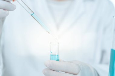 Scientist analyze biochemical samples in advanced scientific laboratory. Medical professional use dropper mix microbiological developmental of viral. Biotechnology research in  science lab. cosmetic