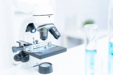 Gelişmiş bilim laboratuarındaki biyokimyasal örnekleri analiz et. Tıbbi profesyonel kullanım mikroskobu virüsün mikrobiyolojik gelişimini gösteriyor. Fen laboratuvarında biyoteknoloji araştırması