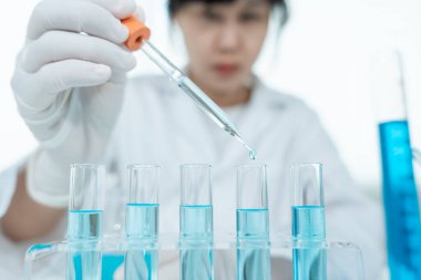 Scientist analyze biochemical samples in advanced scientific laboratory. Medical professional use dropper mix microbiological developmental of viral. Biotechnology research in  science lab. cosmetic