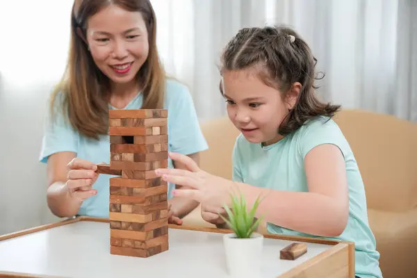 stock image Asia Happy mother playing learning games jan-ga with the little girl. Funny family is happy and excited in the house. mother and son having fun spending time together. holiday, weekend, vacant.