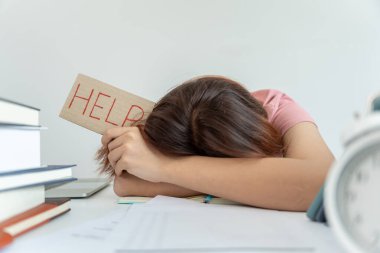 Asian student woman have anxiety because of exams, female prepare for test and learning lessons in the library. stress, despair, haste, misunderstanding reading, discouraged, expectation, knowledge