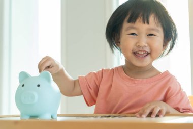 Save money. children putting coin for saving. wealth, Finance, insurance, investment, education, future, plan life, learn, banking, family, health, health and accident insurance.