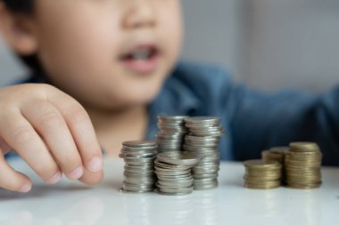 Save money. children putting coin for saving. wealth, Finance, insurance, investment, education, future, plan life, learn, banking, family, health, health and accident insurance.