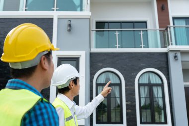inspector engineer and owner project is inspecting construction and quality assurance new house. Engineers or architects or contactor work to build the house before handing it over to the homeowner