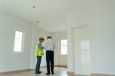 inspector engineer and owner project is inspecting construction and quality assurance new house. Engineers or architects or contactor work to build the house before handing it over to the homeowner