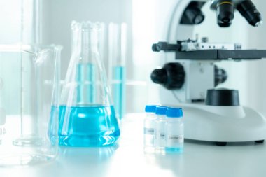 Gelişmiş bilim laboratuarındaki biyokimyasal örnekleri analiz et. Tıbbi profesyonel kullanım mikroskobu virüsün mikrobiyolojik gelişimini gösteriyor. Fen laboratuvarında biyoteknoloji araştırması.