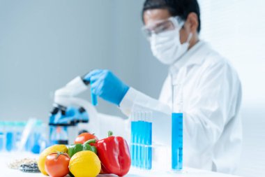 Scientist check chemical food residues in laboratory. Control experts inspect quality of fruits, vegetables. lab, hazards, ROHs, find prohibited substances, contaminate, Microscope, Microbiologist
