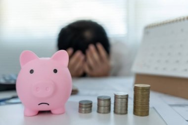 Stressed and headache man with large bills or invoices no money to pay to expenses and credit card debt. shortage, Financial problem, bankruptcy, mortgage, loan, bankrupt, poor, empty wallet