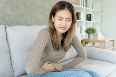 stomach ache. Asian women have abdominal pain, indigestion, gastritis, menstrual cramps, flatulence, diarrhea, distention, colon cancer, belly inflammation problem, suffer food poisoning, abdome