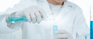 Scientist analyze biochemical samples in advanced scientific laboratory. Medical professional use dropper mix microbiological developmental of viral. Biotechnology research in  science lab. cosmetic