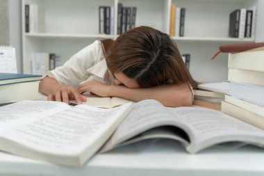 Asian student woman have anxiety because of exams, female prepare for test and learning lessons in the library. stress, despair, haste, misunderstanding reading, discouraged, expectation, knowledge