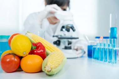 Scientist check chemical food residues in laboratory. Control experts inspect quality of fruits, vegetables. lab, hazards, ROHs, find prohibited substances, contaminate, Microscope, Microbiologist