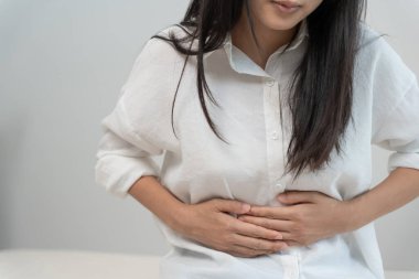 stomach ache. Asian women have abdominal pain, indigestion, gastritis, menstrual cramps, flatulence, diarrhea, distention, colon cancer, belly inflammation problem, suffer food poisoning, abdome