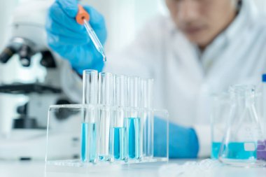 Scientist analyze biochemical samples in advanced scientific laboratory. Medical professional use dropper mix microbiological developmental of viral. Biotechnology research in  science lab. cosmetic