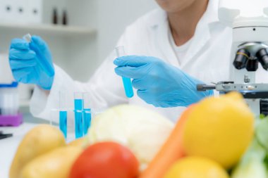 Scientist check chemical food residues in laboratory. Control experts inspect quality of fruits, vegetables. lab, hazards, ROHs, find prohibited substances, contaminate, Microscope, Microbiologist