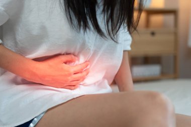 stomach ache. Asian women have abdominal pain, indigestion, gastritis, menstrual cramps, flatulence, diarrhea, distention, colon cancer, belly inflammation problem, suffer food poisoning, abdomen
