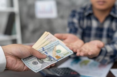 Businessmen receive salary or bonuses from management or Boss. Company give rewards to encourage work. Smiling businessman enjoying a reward at the desk in the office.