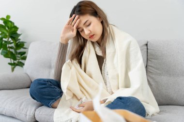 sick woman with a headache and feeling cold on sofa, female sneezing and runny nose with seasonal influenza, allergic, high fever and influenza, resting, virus, coronavirus, feel illness, respiratory