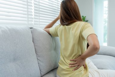 Kadın belini tutuyor ve dayanılmaz ağrılar çekiyor. Sağlık ve sorunlar, kronik sırt ağrısı, ofis sendromu, skolyoz, bel fıtığı, kas iltihabı.