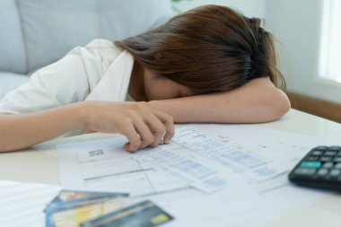 Yüklü faturaları ve faturaları olan stresli ve baş ağrısı çeken Asyalı kadın harcamaları ve kredi kartı borçlarını ödeyecek parası yok. kıtlık, mali sorunlar, mortgage, kredi, iflas, iflas, yoksul, boş cüzdan