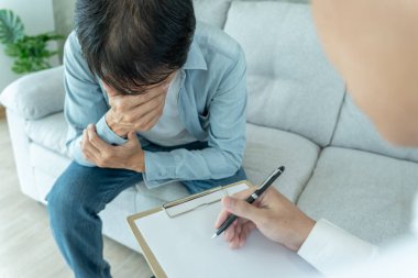 man with mental health problems is consulting. psychiatrist is recording the patient's condition for treatment. encouragement, love and family problem, bipolar , depression patient, protect suicide