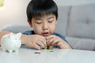 Save money. children putting coin for saving. wealth, Finance, insurance, investment, education, future, plan life, learn, banking, family, health, health and accident insurance.