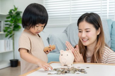 Save money. children putting coin for saving. wealth, Finance, insurance, investment, education, future, plan life, learn, banking, family, health, health and accident insurance.