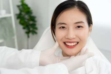 Plastik cerrahi, güzellik, cerrah ya da kadın yüzüne dokunan güzellik uzmanı, yüz şeklinin değiştirilmesini içeren cerrahi prosedür, doktor hastanın yüzünü muayene eder, tıbbi yardım, sağlık