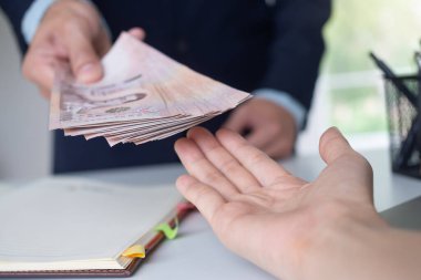 Businessmen receive salary or bonuses from management or Boss. Company give rewards to encourage work. Smiling businessman enjoying a reward at the desk in the office.