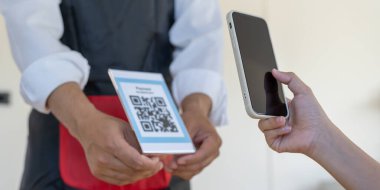 Woman use smartphone to scan QR code to pay in cafe restaurant with a digital payment without cash. Choose menu and order accumulate discount. E wallet, technology, pay online, credit card, bank app.