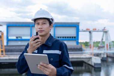 maintenance and inspector. Maintenance engineers are using tablet to checking results of inspection of buildings and structures. Irrigation engineers are exploring sluice systems clipart