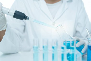 Scientist analyze biochemical samples in advanced scientific laboratory. Medical professional use dropper mix microbiological developmental of viral. Biotechnology research in  science lab. cosmetic