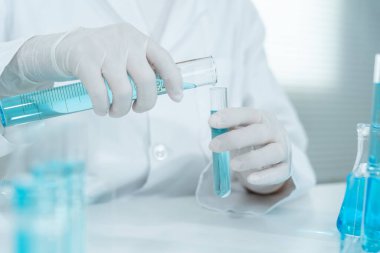 Scientist analyze biochemical samples in advanced scientific laboratory. Medical professional use dropper mix microbiological developmental of viral. Biotechnology research in  science lab. cosmetic