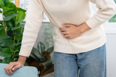 stomach ache. Asian women have abdominal pain, indigestion, gastritis, menstrual cramps, flatulence, diarrhea, distention, colon cancer, belly inflammation problem, suffer food poisoning, abdomen